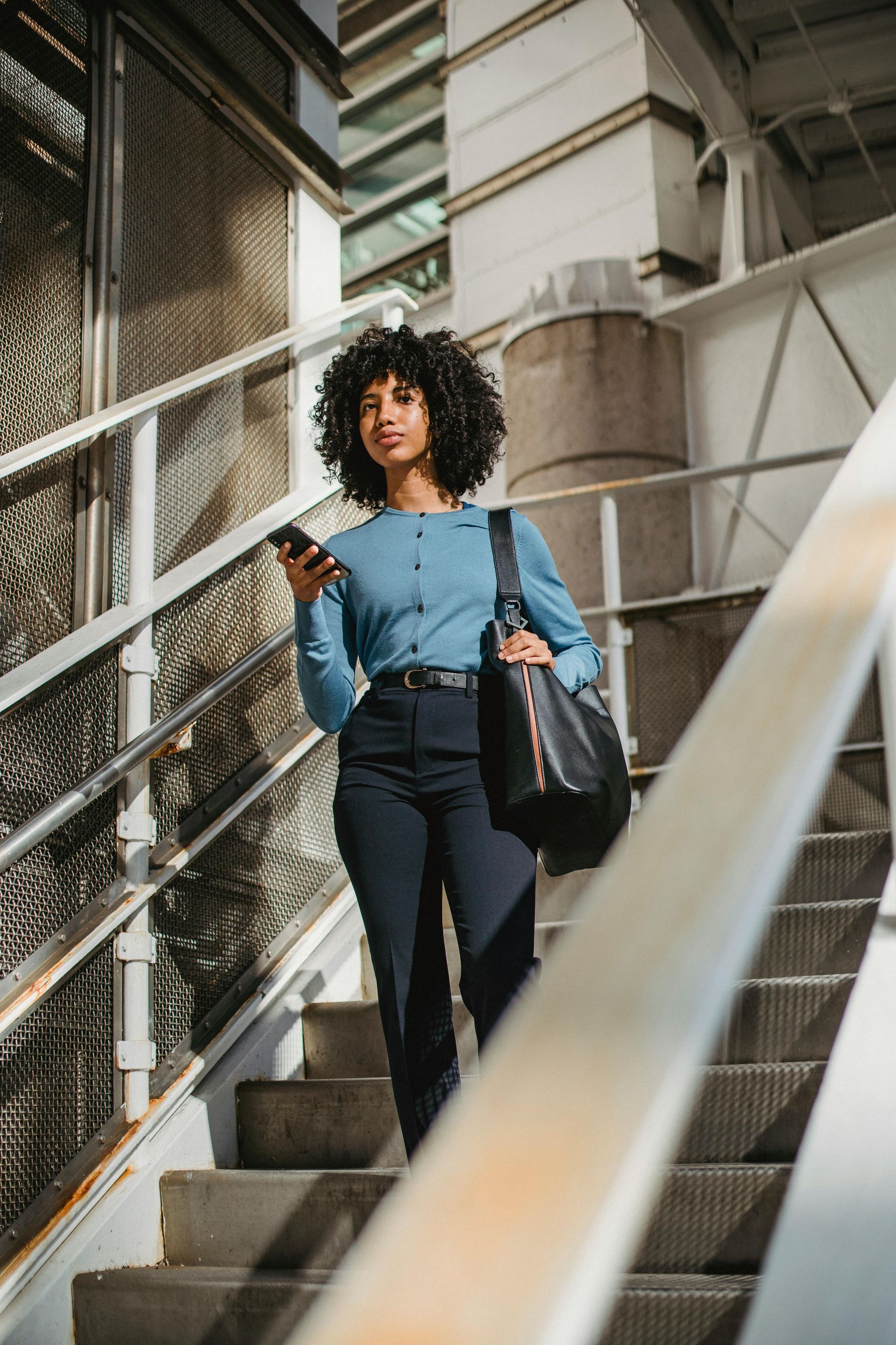 Woman on industrial stairs.